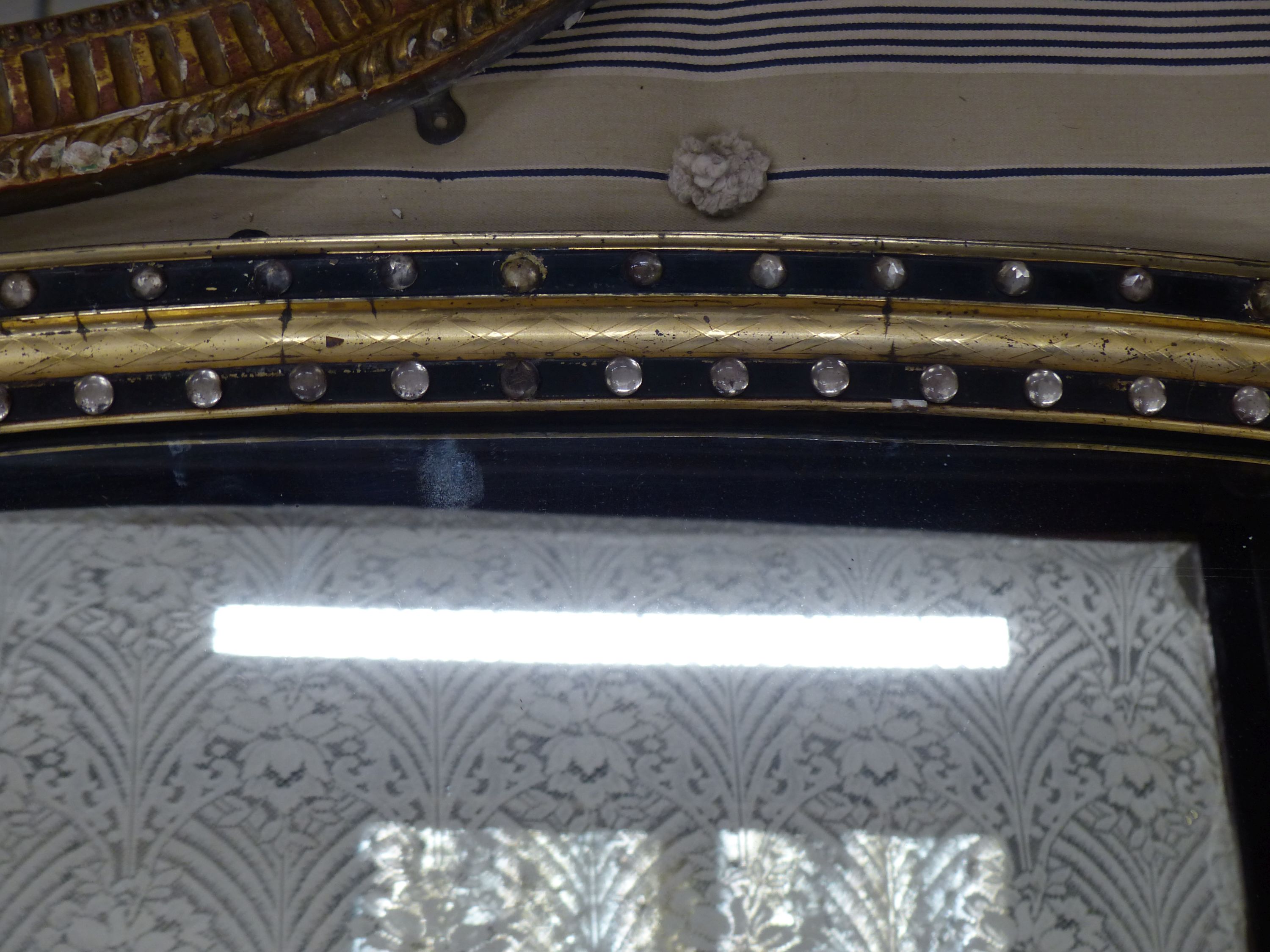 An early Victorian parcel gilt ebonised overmantel mirror with glass bead decortion in the Irish manner, width 105cm, height 68cm